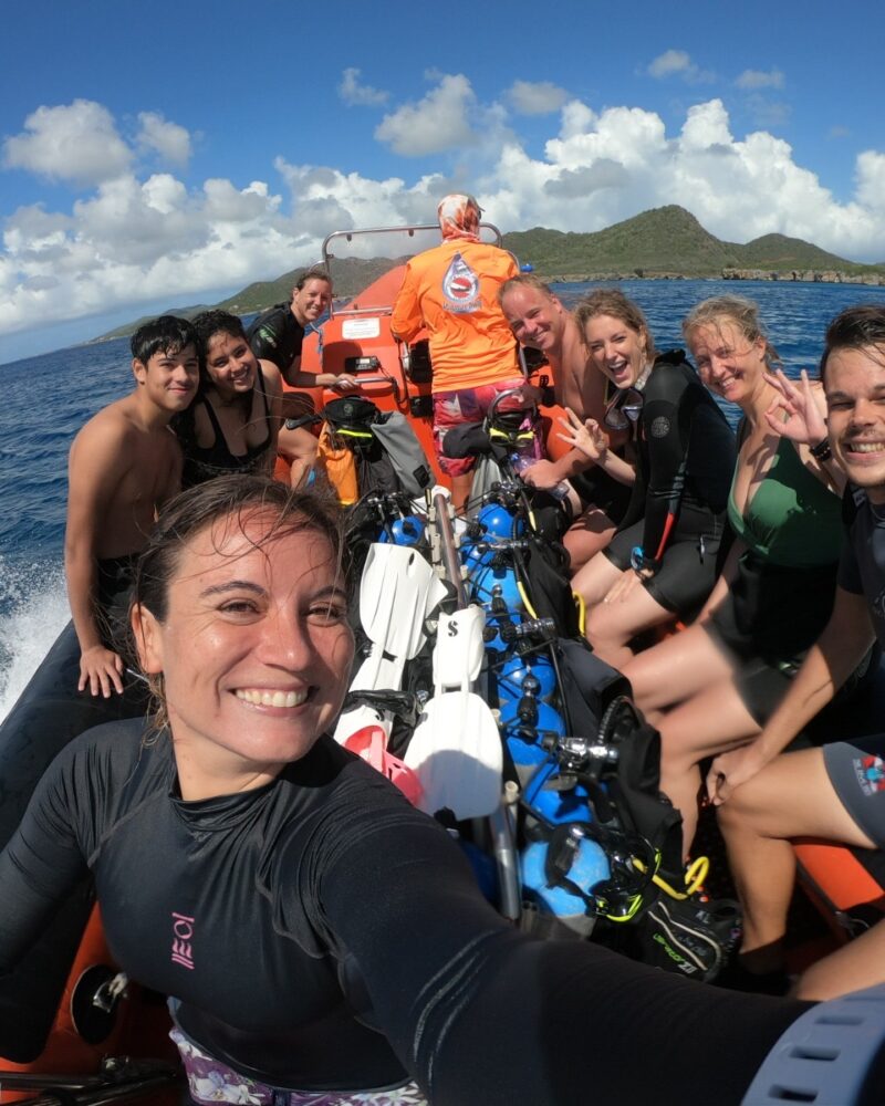 happy divers on a boat