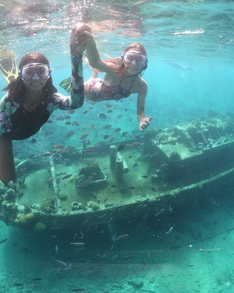 two girls snorkeling at a wreck